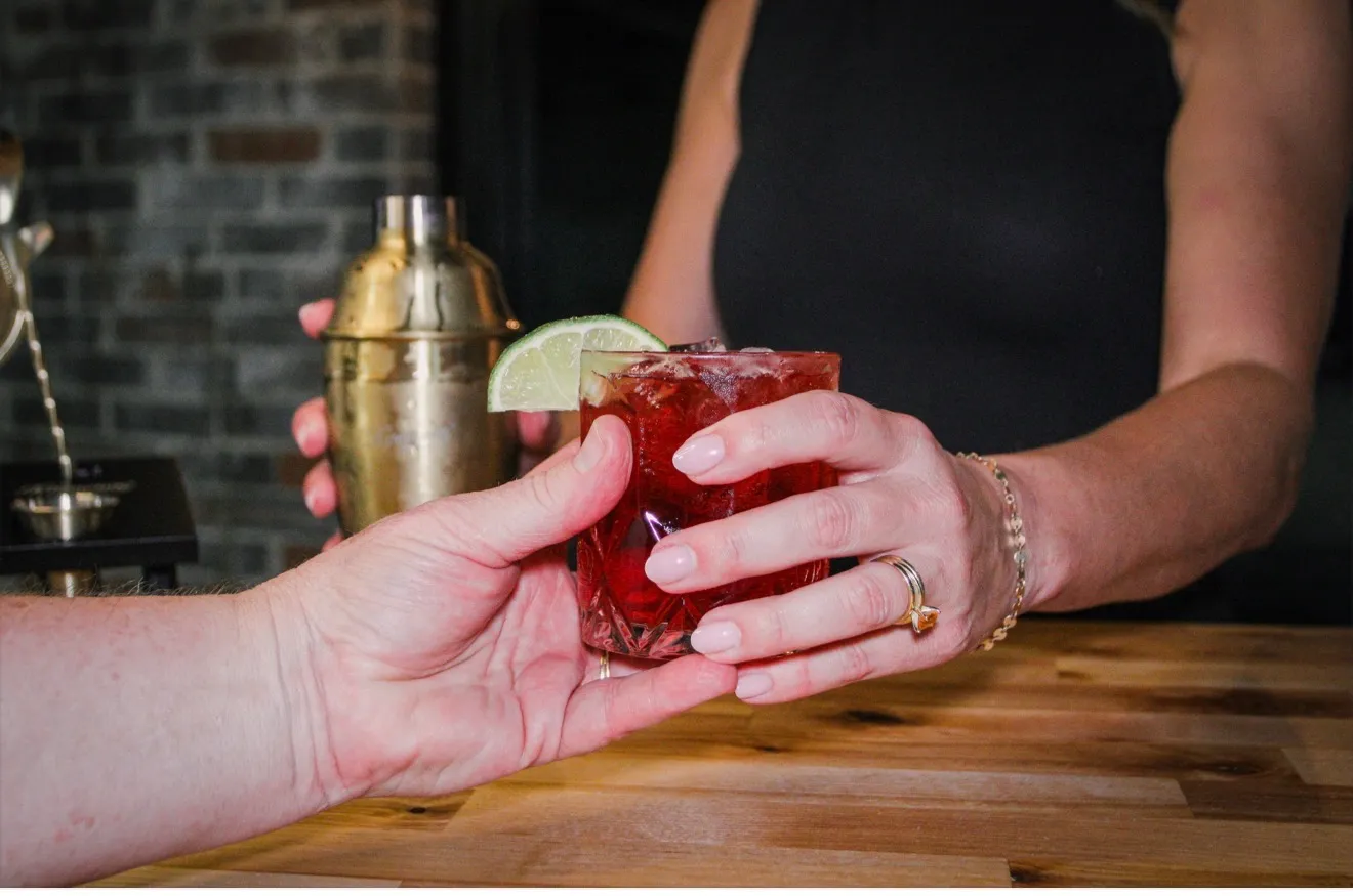 A cocktail handed across the bar at Depot Square Events