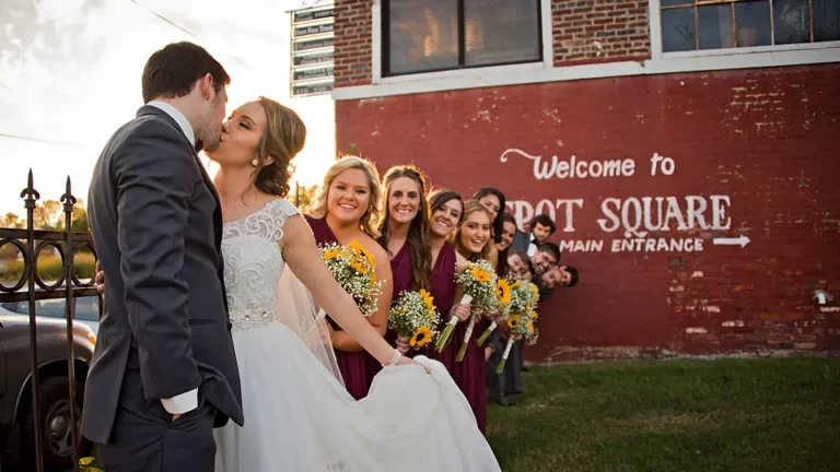 Newlyweds and the wedding party by the painted Depot Square wall